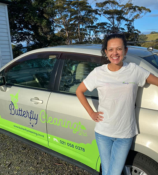 Juliana Da Silva standing next to Butterfly Cleaning company car